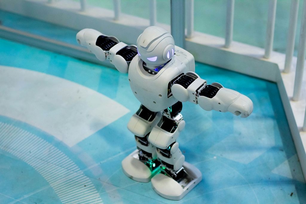 a toy robot standing on a blue floor
